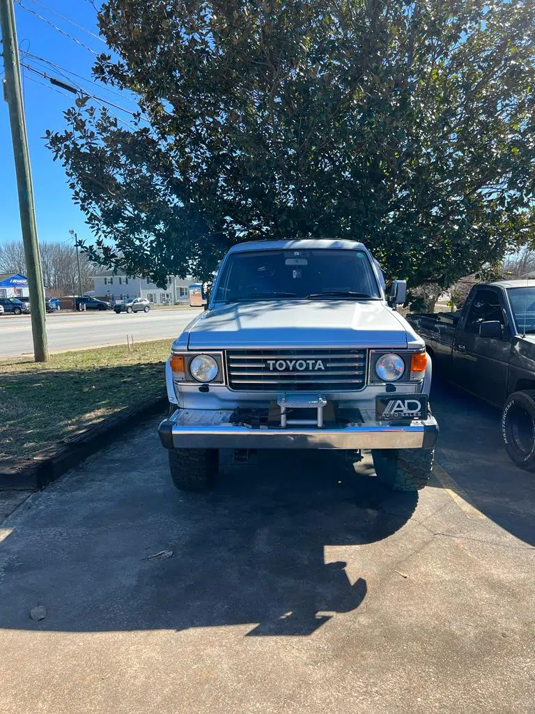 Restored silver Toyota Land Cruiser parked under a tree — PIQUET AUTO SERVICE in Greenville
