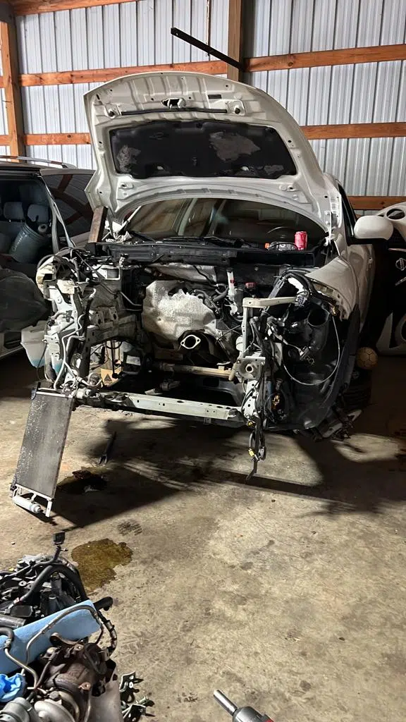 Vehicle with hood open and engine bay stripped for repair — PIQUET AUTO SERVICE in Greenville